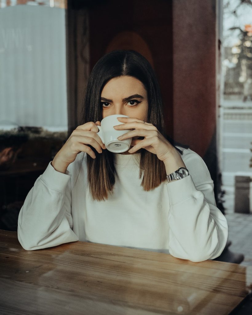 Photo of Woman Drinking on Cup