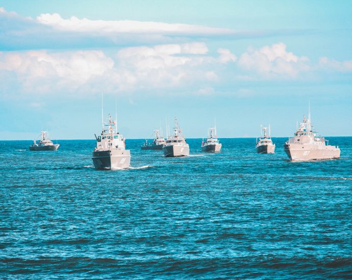 seven navy ship sailing on ocean during daytime
