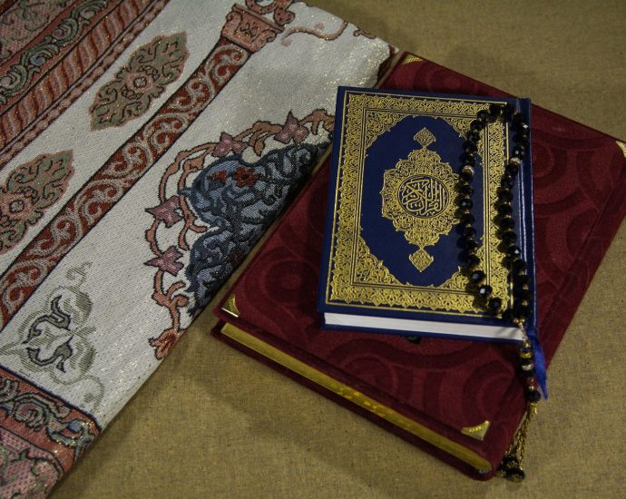 red and blue book on white and blue floral textile