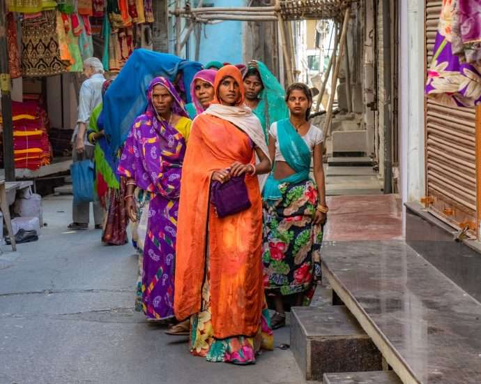 standing women wearing sari dress