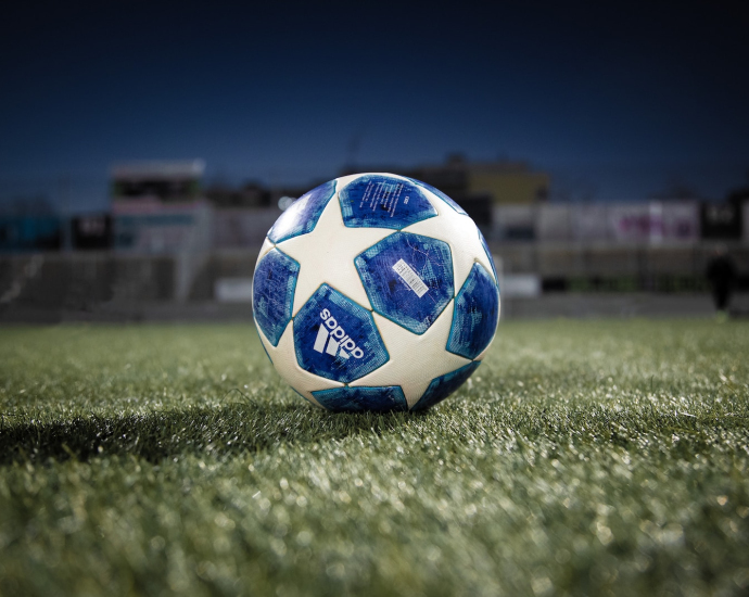 white blue soccer ball on green grass field during daytime