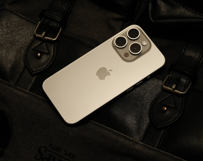 a white iphone sitting on top of a black bag
