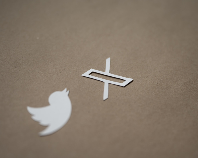 a white twitter logo and a white twitter sticker