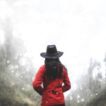 woman in red shirt standing near forest