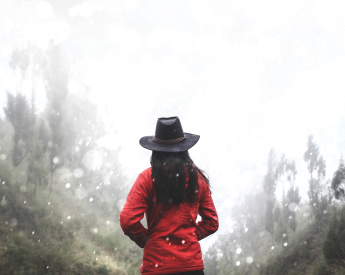 woman in red shirt standing near forest