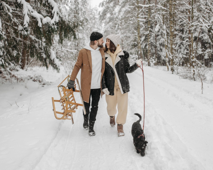 A Couple Walking Their Pet Dog during Winter