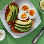 a white plate topped with eggs and avocado