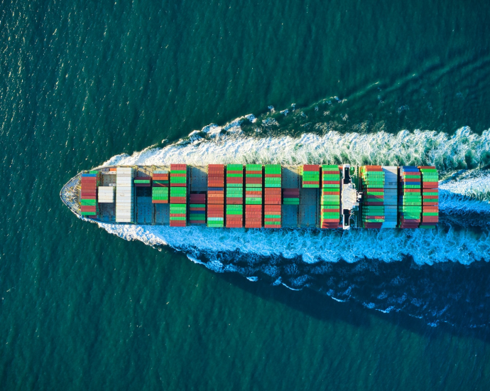 aerial view of blue and white boat on body of water during daytime