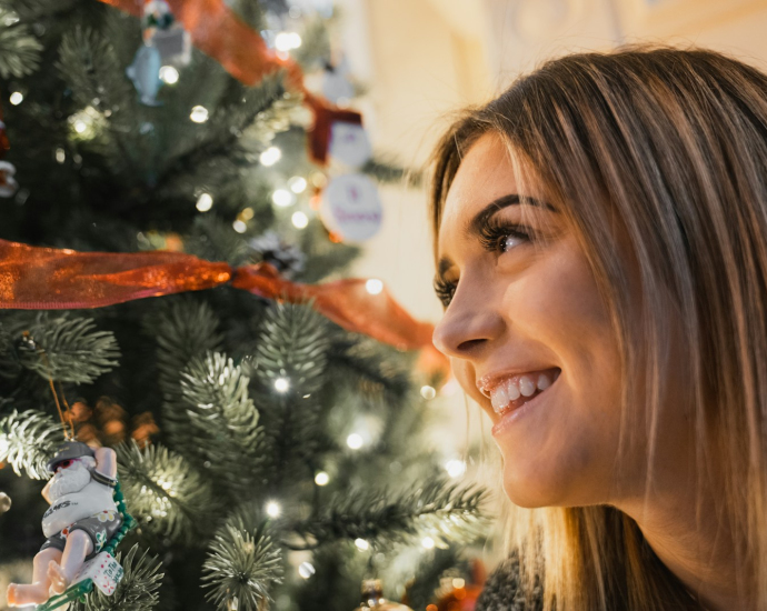 smiling woman near green Christmas tree