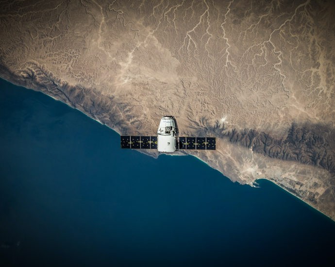 A space satellite hovering above the coastline