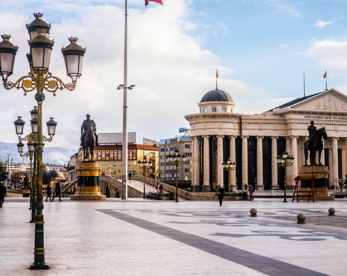 Square with sculptures and old national museum in Macedonia