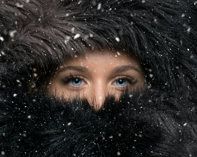 woman covered with black furred headscarf during winter