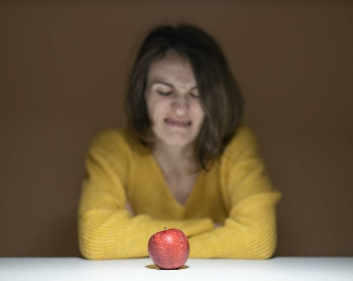 Woman Disgusted Looking at the Apple
