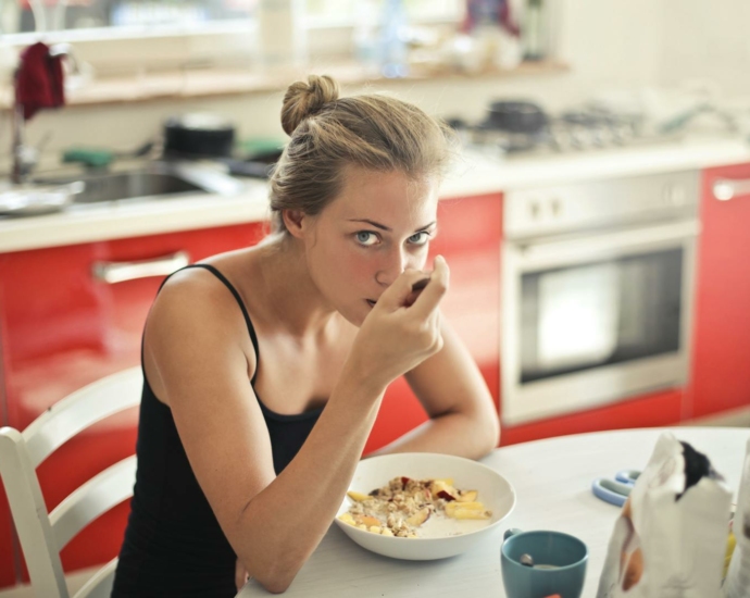 Woman in Black Tank Top Eating Cereals