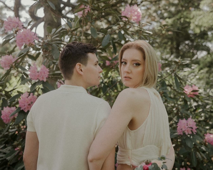 Blonde Woman and Man Posing near Spring Blossoms on Bush