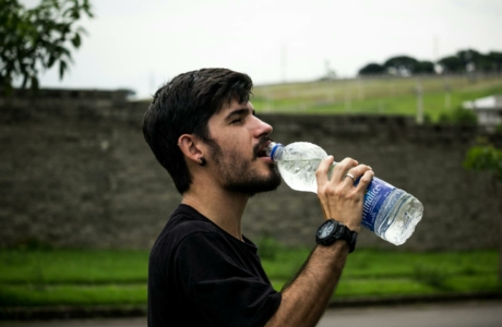 Man Wearing Black Shirt Drinking Water