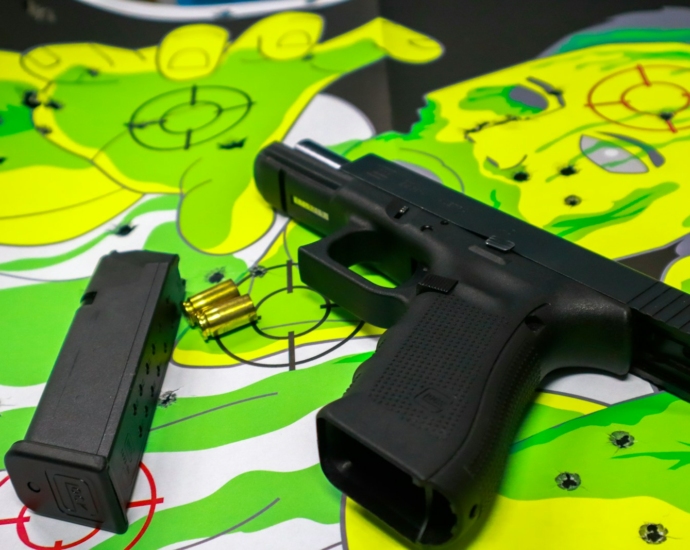 black semi automatic pistol on green and white textile