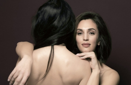 a woman is hugging another woman's back