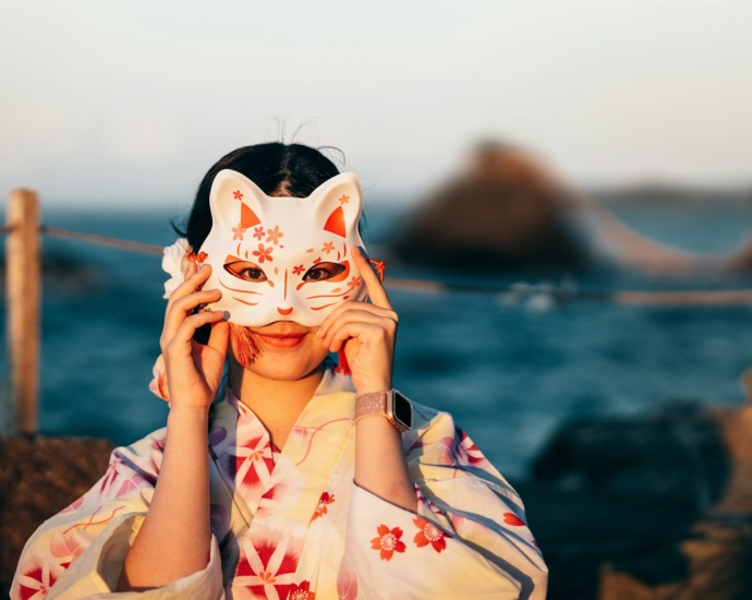a woman with a cat mask covering her face