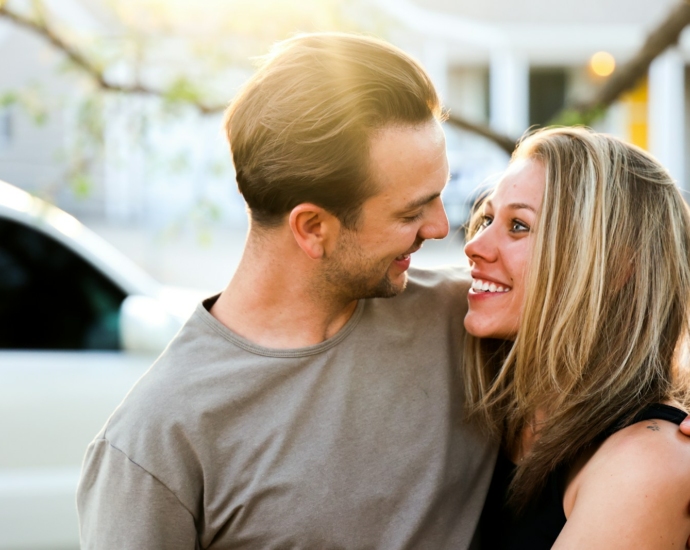 man in gray crew neck shirt kissing woman in black tank top