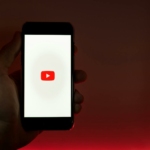 Hand Holding Smartphone with Internet Access to YouTube