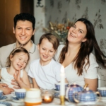 Loving family laughing at table having cozy meal