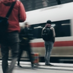 people standing beside train