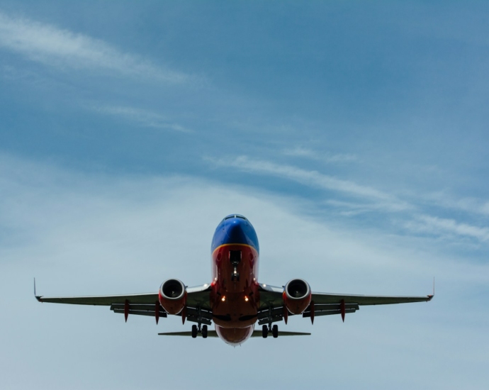 blue and red airplane on sky