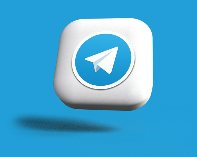 a blue and white square button with a paper airplane on it