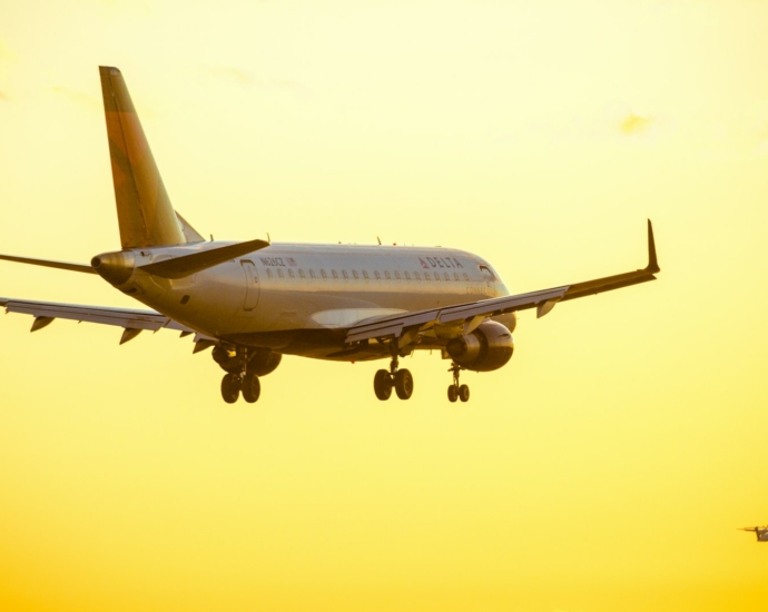 white passenger plane in mid air during daytime