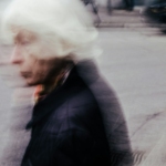 a blurry photo of a man walking down a street