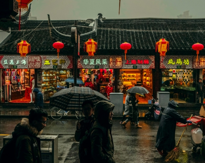 person carrying umbrellas