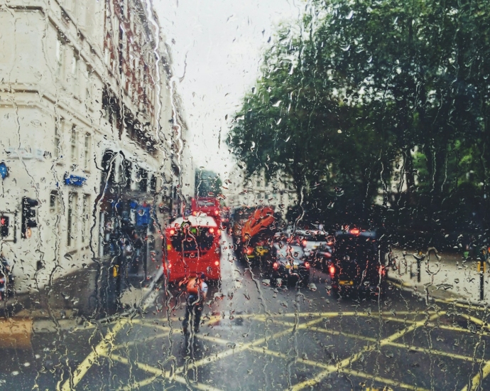 photo of red bus on street from window