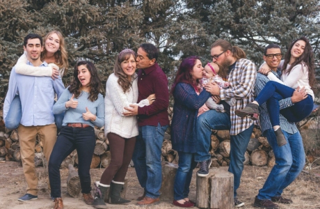 People Standing in Front of Wood Pile