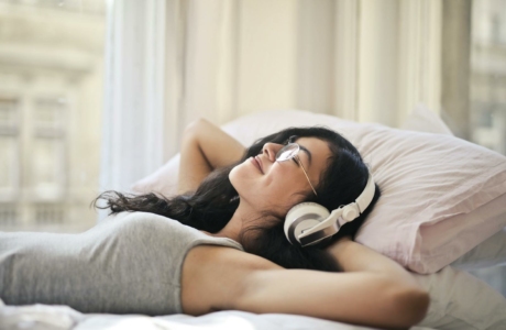 Woman in Gray Tank Top Lying on Bed