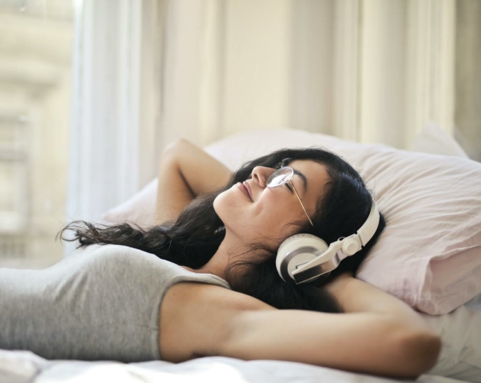 Woman in Gray Tank Top Lying on Bed