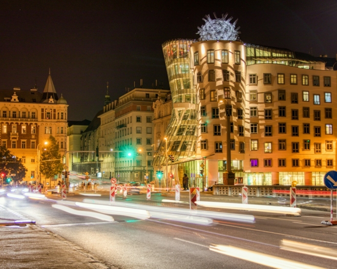 lighted brown concrete building at night