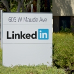 brown wooden signage on green grass field