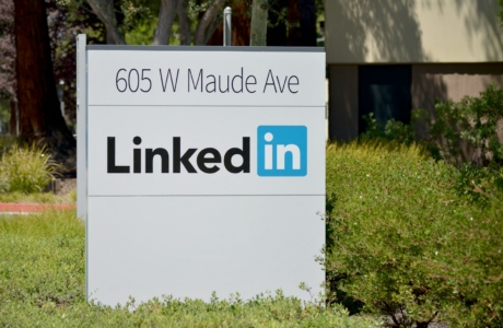 brown wooden signage on green grass field