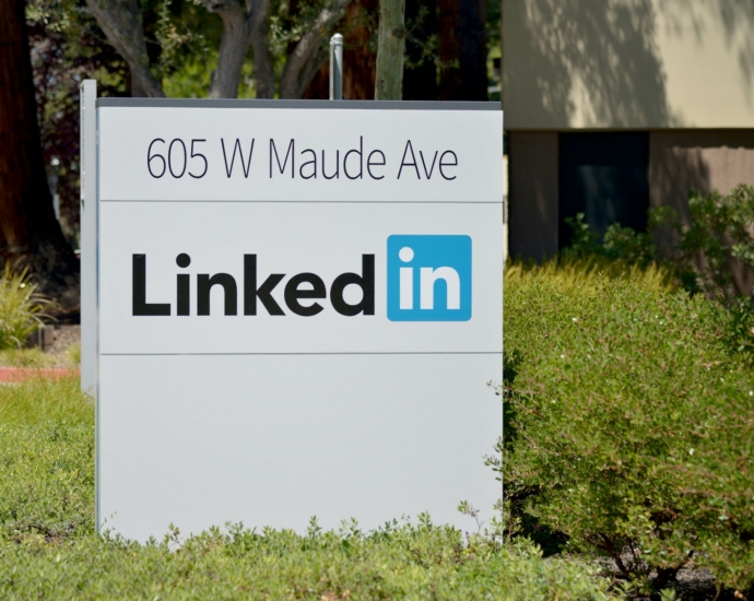 brown wooden signage on green grass field