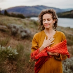 A woman in a yellow dress standing in a field