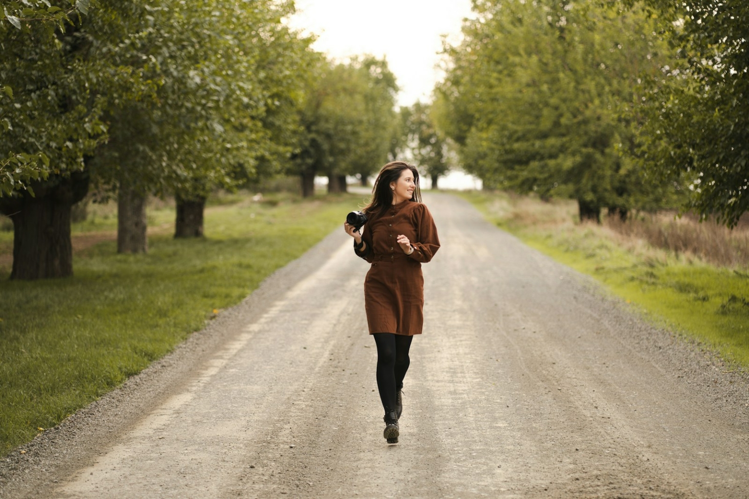 A woman is running down a dirt road