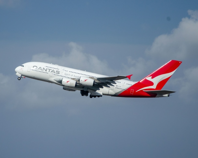 a large passenger jet flying through a cloudy blue sky