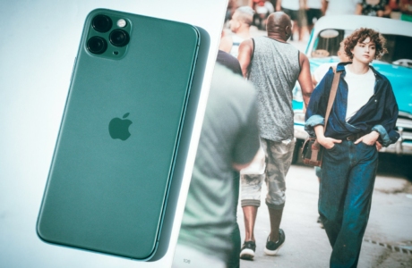 a picture of a man walking down a street next to a cell phone