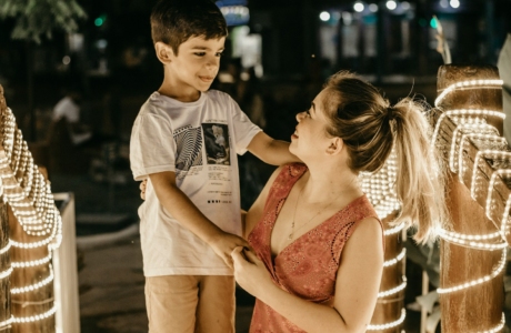 a woman and a boy standing next to each other