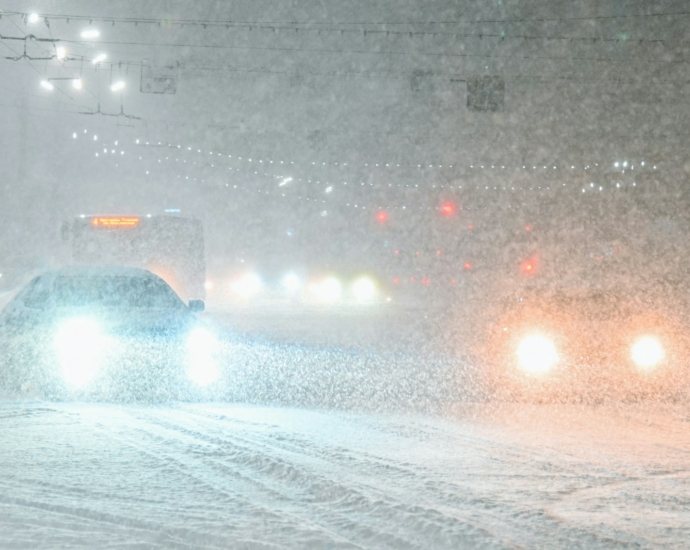 a car driving down a snow covered road