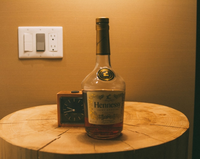 a bottle of henness gin on a wooden table