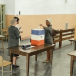 A young African American woman casting her ballot in 1964