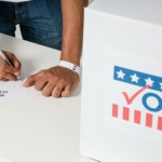 A Person with a Wristband Casting a Vote