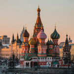 Stunning view of St. Basil's Cathedral in Moscow during sunset with a bustling crowd.